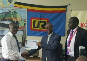URC Acting Managing Director Engineer Charles Kateeba hands over the concession for the passenger services to RVR's Charles Ssentongo