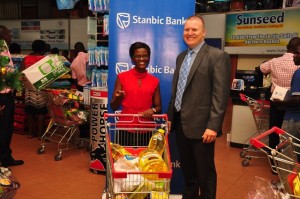 Wayne Cook, Stanbic Uganda’s Head of Business Banking congratulates Maria Nattabi, one of the three lucky winners of the first draw in Stanbic’s XmasDash campaign 