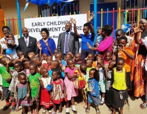 Patrick Mweheire (centre) Chief Executive of Stanbic Bank Uganda poses for a group photo with children and officials (Left to Right) Stanbic Bank’s Non – Executive Director Ruth Emunu, Ka Tutandike Board Chairperson Steven Jingo, Chairperson Ka Tutandike Trust UK Anisha Rajapakse, Stanbic’s Corporate Affairs Manager Cathy Adengo, Ggaba Market women’s Chairperson Immaculate Kazibwe at the recently launched Ggaba Market Early Development Centre in Bunga. The facility that handles 30 kids a day was constructed by Stanbic Bank in partnership with Ka Tutandike, provides quality day-care services for infant children from families working in the nearby Ggaba market