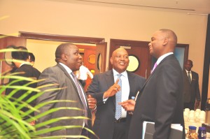 Jimmy Mugerwa, the Tullow Oil Uganda General Manager has a chat with Mbire and Mweheire at the conference