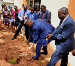 Mweheire plants a commerative tree as MUK sff look on